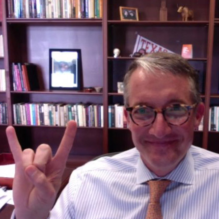 President Jay Hartzell makes the hook 'em horns hand gesture while on a zoom call