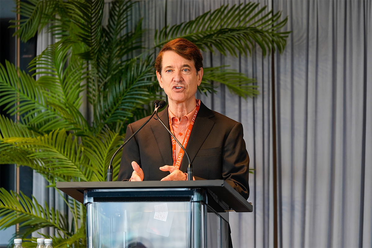 Jim Breyer, founder and CEO of Breyer Capital, speaks on stage at a podium at the Life Science & Healthcare Innovation Summit.